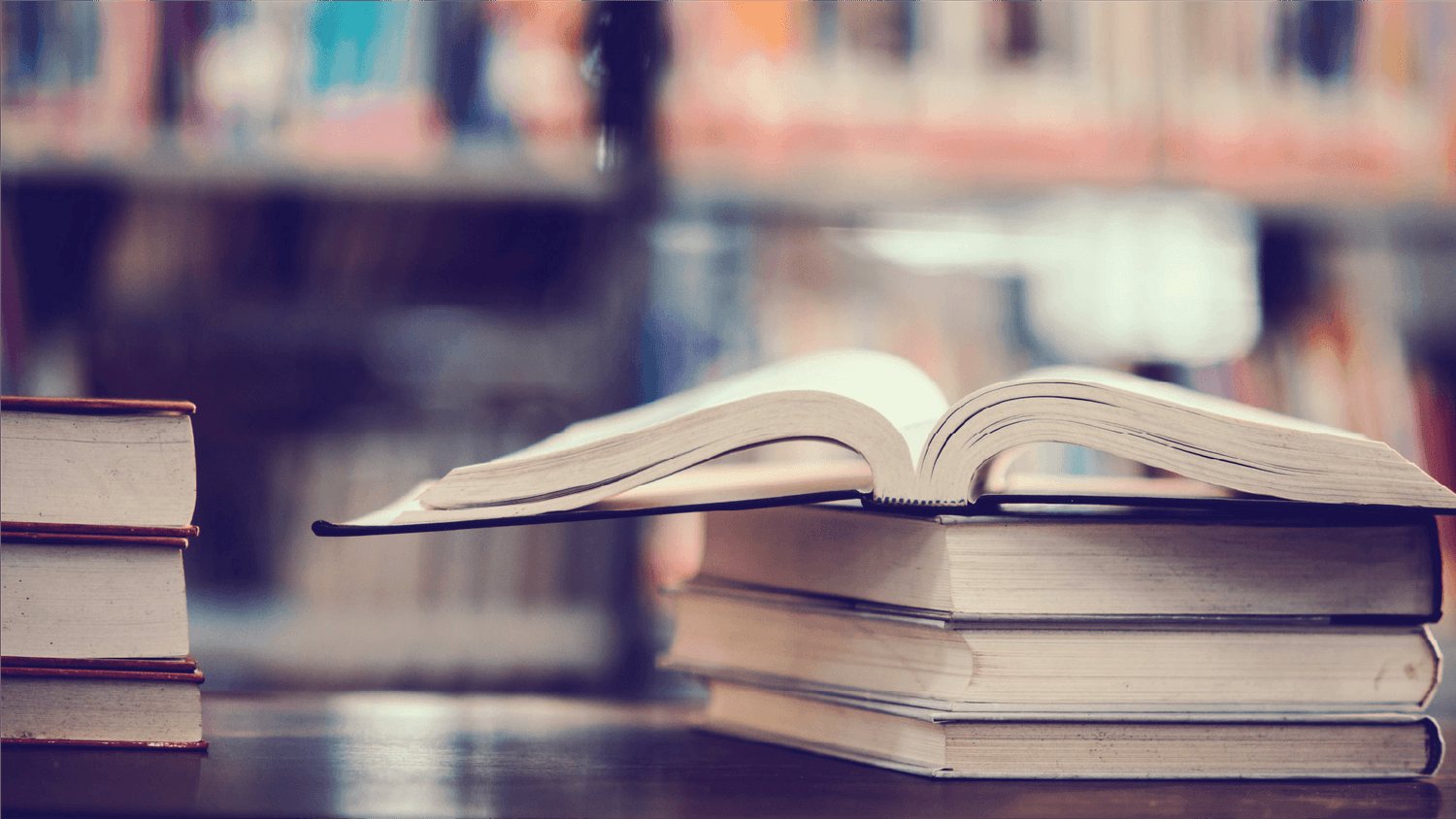An open book on a table in a library